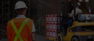 Manufacturing plant workers with forklift, safety vest, hard hat and safety glasses